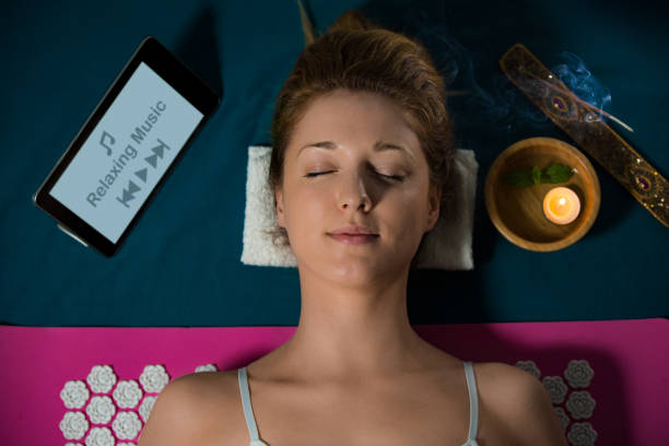 Softly lit room with a candle and a yoga mat
